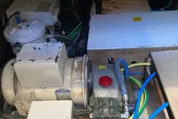 Engine room of a 1991 Trader 47 boat with visible machinery and wiring.