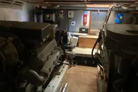 Engine room of a 1991 Trader 47 yacht, featuring dual engines and control systems.