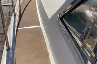 1991 Trader 47 yacht deck with railing and window, showcasing sleek design and craftsmanship.