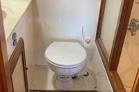 Bathroom interior of 1991 Trader 47 yacht with toilet and wooden accents.