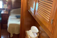 1991 Trader 47 yacht interior with wooden cabinetry and cozy bedroom.