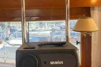 Speaker system inside 1991 Trader 47 yacht, featuring wooden interior and nautical decor.