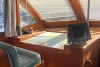 Interior of 1991 Trader 47 yacht with wooden finish and navigation equipment.