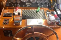 1991 Trader 47 yacht helm with wooden wheel and instrument panel.