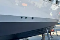1991 Trader 47 yacht hull in dry dock, showcasing sleek design and maintenance work.
