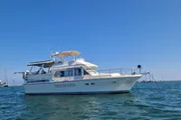 1991 Trader 47 yacht on calm blue waters under clear sky.