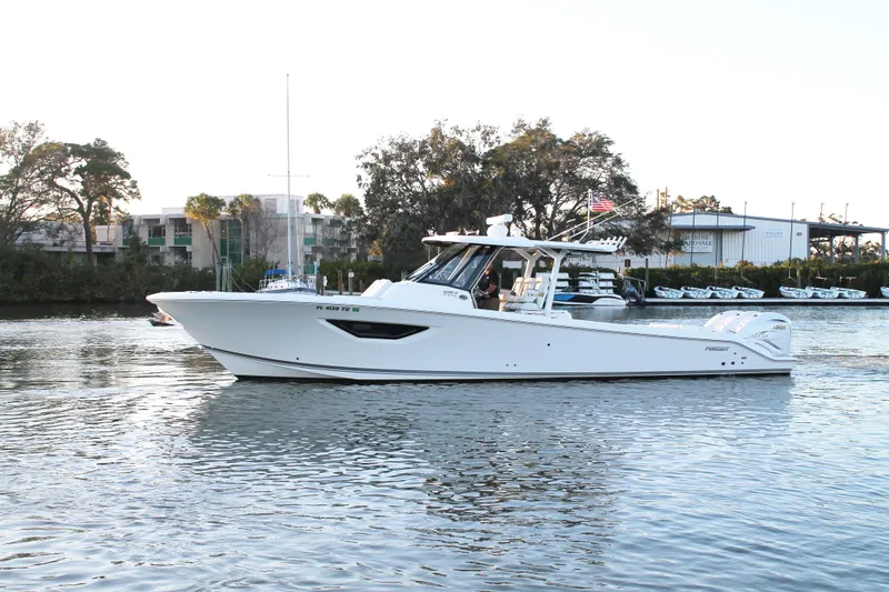  Yacht Photos Pics 2023 Pursuit S 378 Sport boat cruising on a calm river.