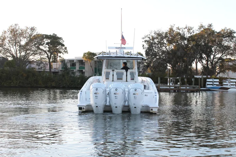  Yacht Photos Pics 2023 Pursuit S 378 Sport boat with triple engines on a calm river.