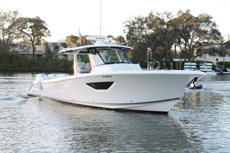  Yacht Photos Pics 2023 Pursuit S 378 Sport boat cruising on a calm waterway.