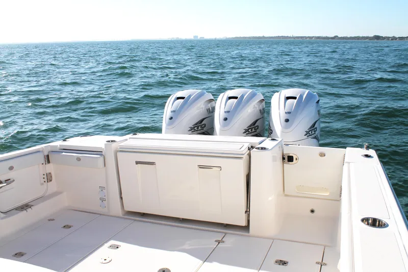  Yacht Photos Pics 2023 Pursuit S 378 Sport boat with triple outboard engines on open water.