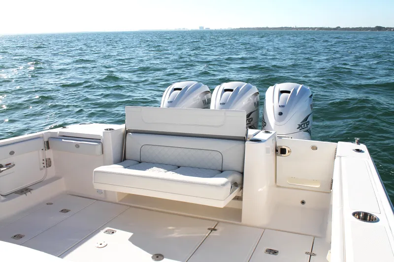  Yacht Photos Pics 2023 Pursuit S 378 Sport boat with triple outboard engines on open water.