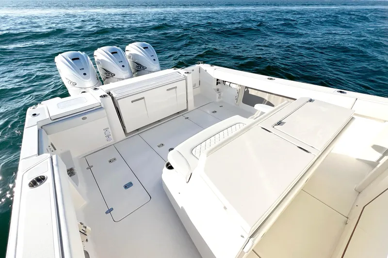  Yacht Photos Pics 2023 Pursuit S 378 Sport boat with triple engines on open water.