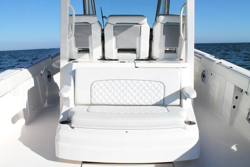  Yacht Photos Pics 2023 Pursuit S 378 Sport boat interior with white seating and ocean backdrop.