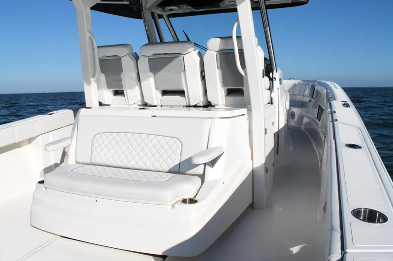  Yacht Photos Pics 2023 Pursuit S 378 Sport boat interior with white seating and ocean view.