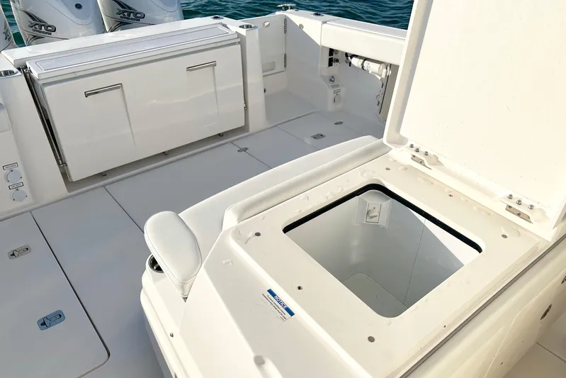  Yacht Photos Pics 2023 Pursuit S 378 Sport boat deck with open storage compartment and Yamaha XTO engines.