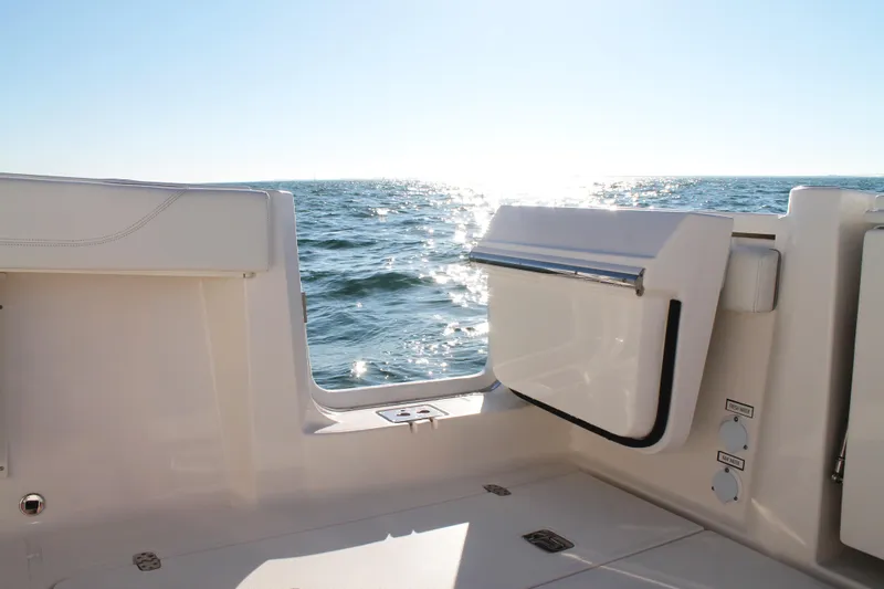  Yacht Photos Pics 2023 Pursuit S 378 Sport boat interior with ocean view and sunlight reflection.