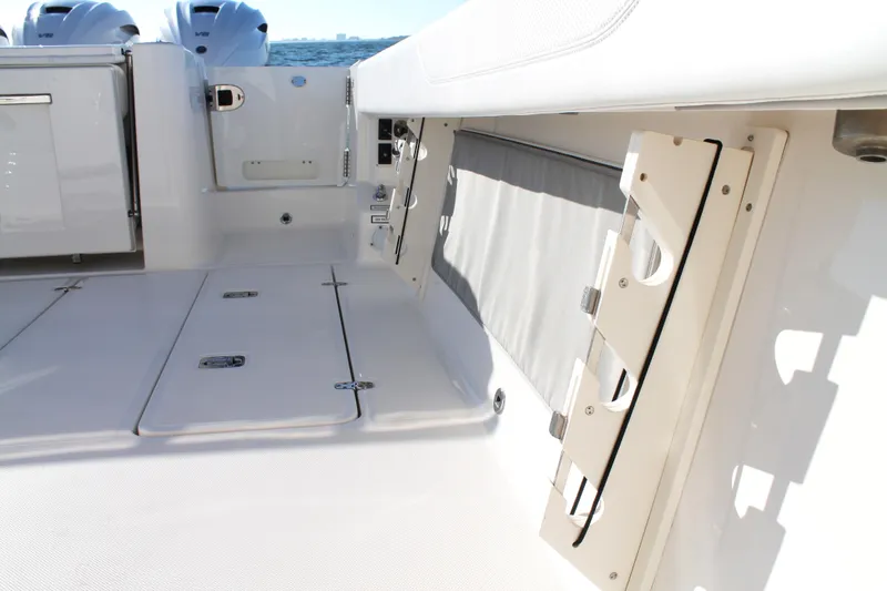  Yacht Photos Pics 2023 Pursuit S 378 Sport boat interior with storage compartments and sleek design.