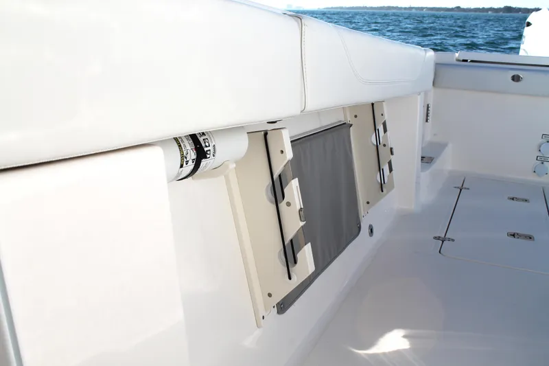  Yacht Photos Pics 2023 Pursuit S 378 Sport boat interior with storage compartments and ocean view.