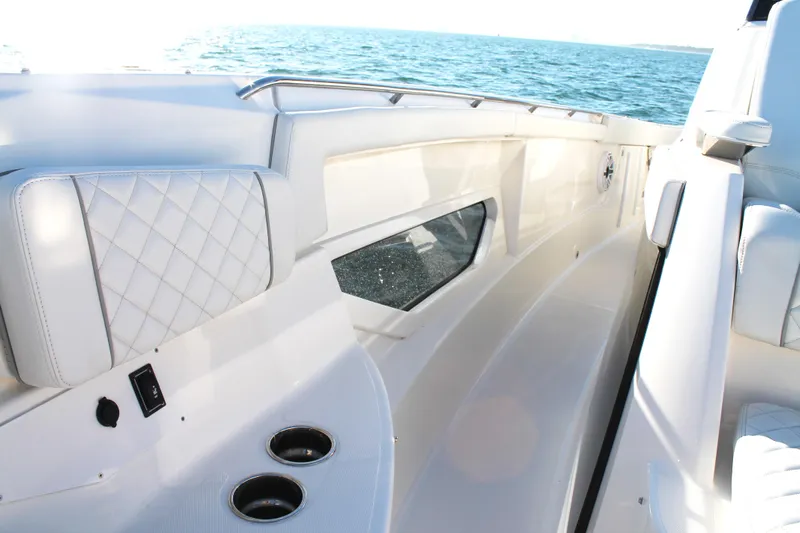  Yacht Photos Pics 2023 Pursuit S 378 Sport boat interior with white seating and ocean view.