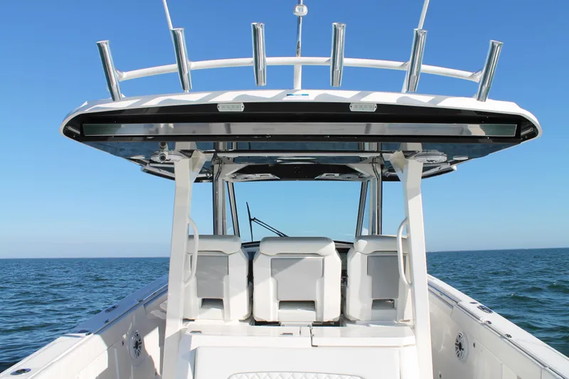  Yacht Photos Pics 2023 Pursuit S 378 Sport boat on open water, featuring sleek design and spacious seating.