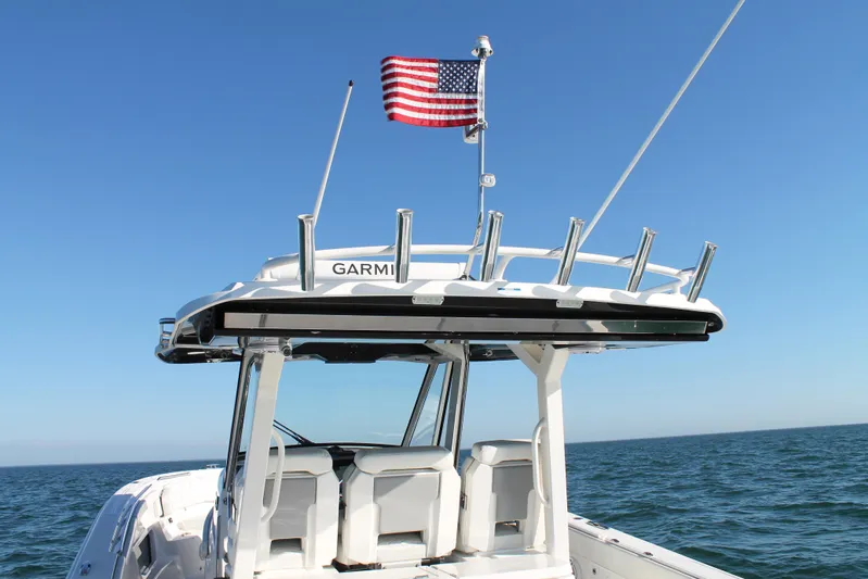  Yacht Photos Pics 2023 Pursuit S 378 Sport boat with American flag on open sea.