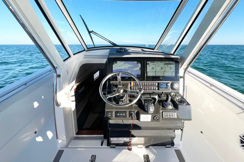  Yacht Photos Pics 2023 Pursuit S 378 Sport boat cockpit with advanced navigation system and ocean view.