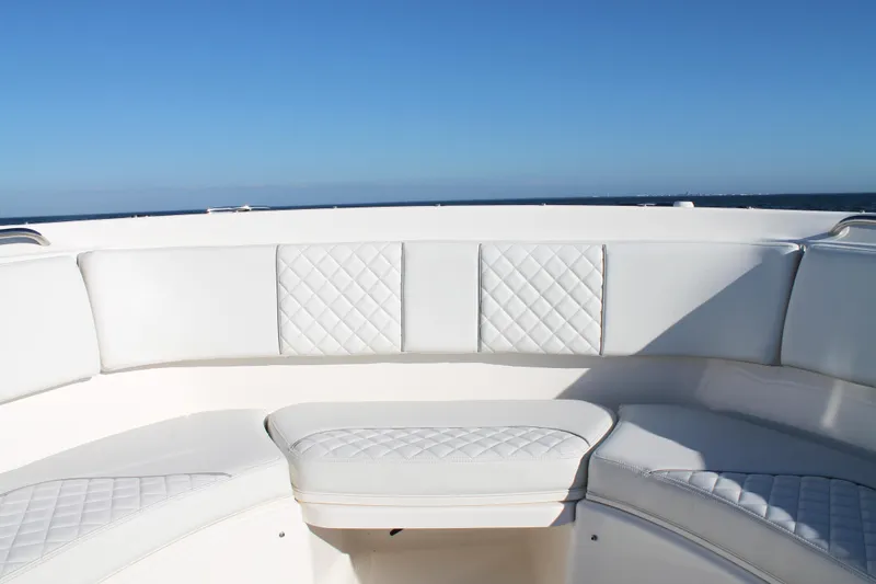  Yacht Photos Pics 2023 Pursuit S 378 Sport boat with white cushioned seating under clear blue sky.