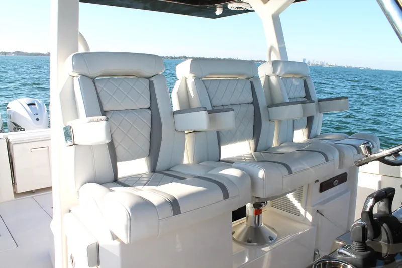  Yacht Photos Pics Luxurious seating on 2023 Pursuit S 378 Sport boat, featuring elegant design and ocean backdrop.