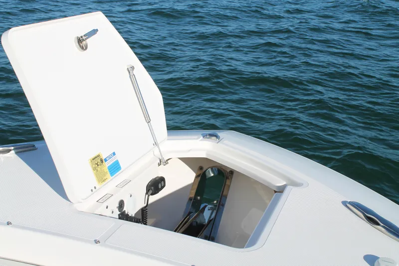  Yacht Photos Pics 2023 Pursuit S 378 Sport boat anchor compartment open on calm water.