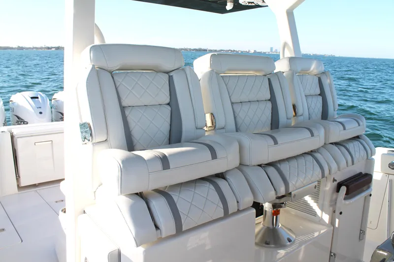  Yacht Photos Pics Luxurious seating on 2023 Pursuit S 378 Sport boat with ocean backdrop.