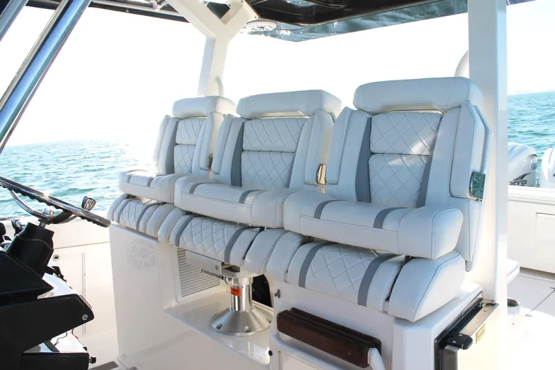  Yacht Photos Pics Luxurious seating on 2023 Pursuit S 378 Sport boat with ocean backdrop.