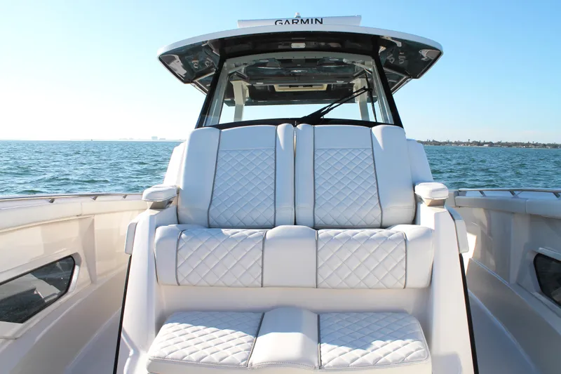  Yacht Photos Pics 2023 Pursuit S 378 Sport boat with luxurious seating on open water.