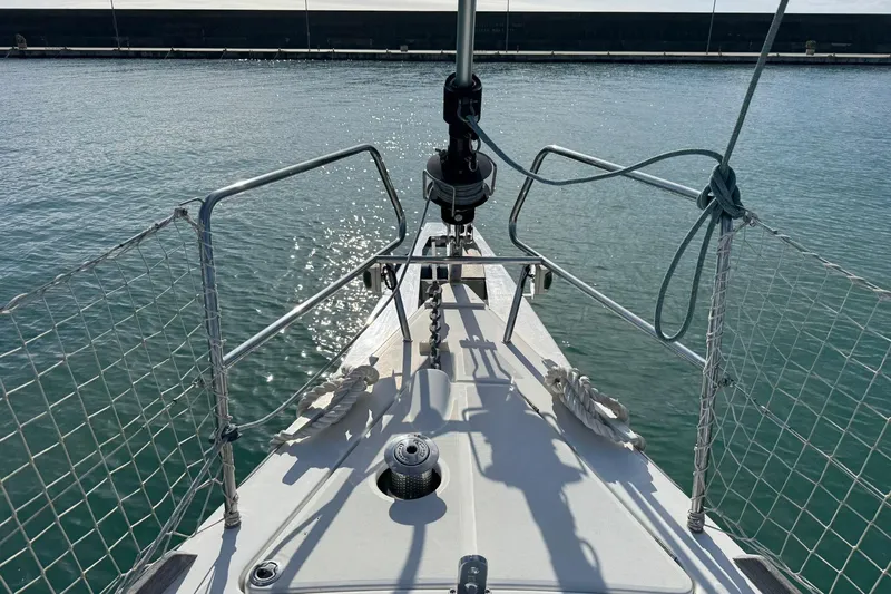  Yacht Photos Pics Bow view of 2017 Beneteau Sense 51 sailboat on calm water.
