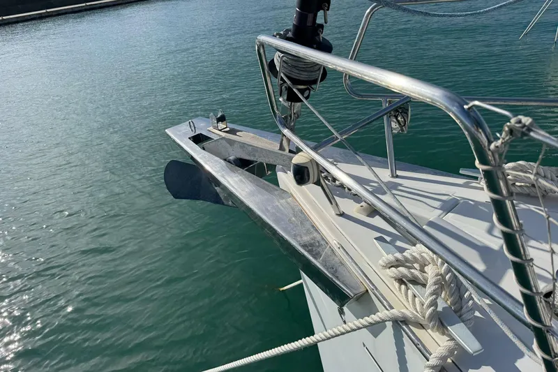  Yacht Photos Pics Bow of 2017 Beneteau Sense 51 yacht with anchor and railing in marina.