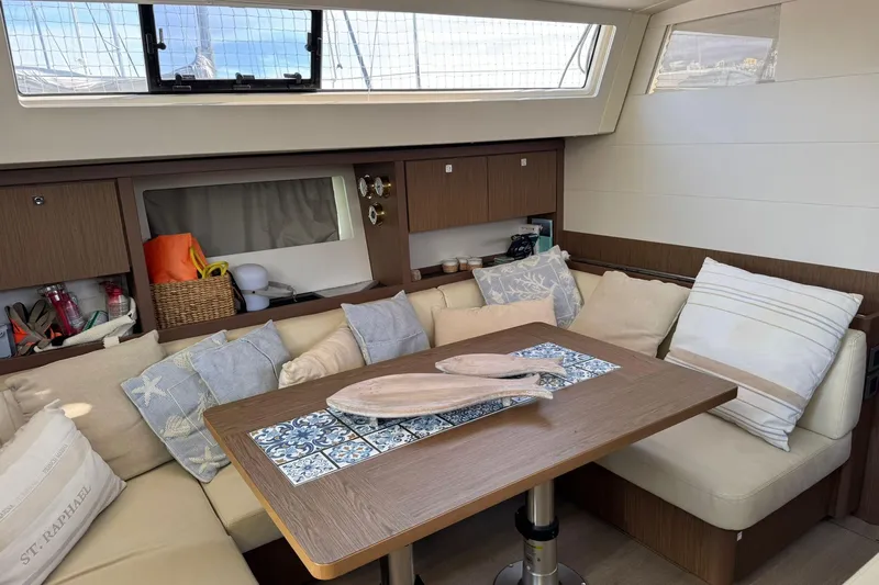  Yacht Photos Pics Interior of 2017 Beneteau Sense 51 yacht with cozy seating and decorative pillows.