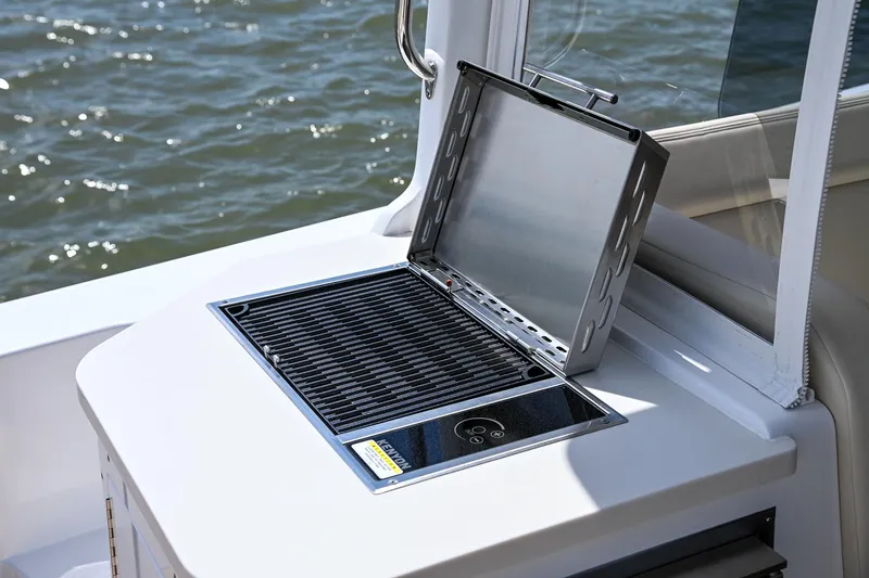 In Stock Yacht Photos Pics Built-in grill on 2025 MJM 35 boat, overlooking water.