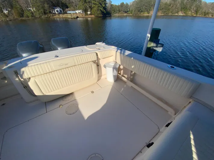 On Wine Time Yacht Photos Pics 2009 Grady-White Chesapeake 290 boat interior with seating, docked by a serene lake.