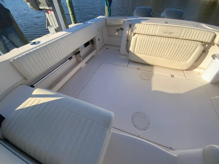 On Wine Time Yacht Photos Pics 2009 Grady-White Chesapeake 290 boat interior with white cushioned seating.