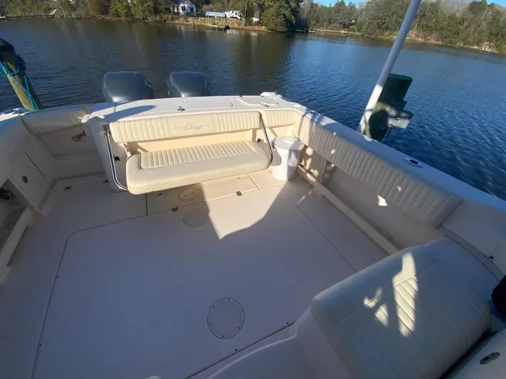 On Wine Time Yacht Photos Pics 2009 Grady-White Chesapeake 290 boat interior with seating, docked on a calm lake.