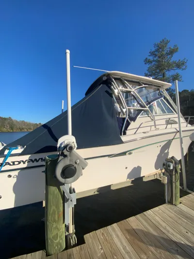 On Wine Time Yacht Photos Pics 2009 Grady-White Chesapeake 290 boat docked under clear blue sky.