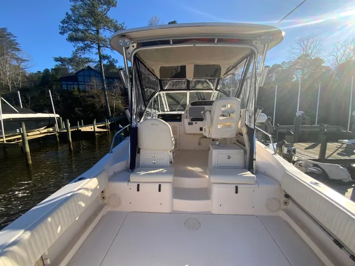 On Wine Time Yacht Photos Pics 2009 Grady-White Chesapeake 290 boat interior with seating and helm, docked by the water.