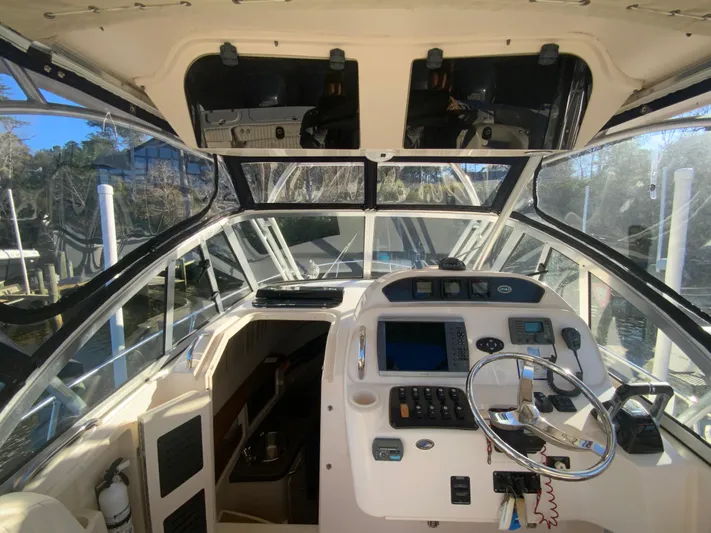 On Wine Time Yacht Photos Pics 2009 Grady-White Chesapeake 290 boat cockpit with steering wheel and navigation controls.