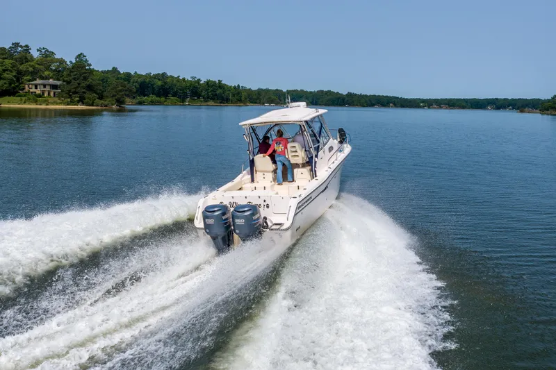 On Wine Time Yacht Photos Pics 2009 Grady-White Chesapeake 290 boat cruising on a serene lake.