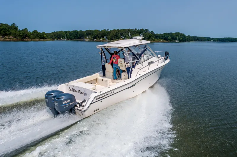 On Wine Time Yacht Photos Pics 2009 Grady-White Chesapeake 290 boat cruising on a lake with twin Yamaha engines.