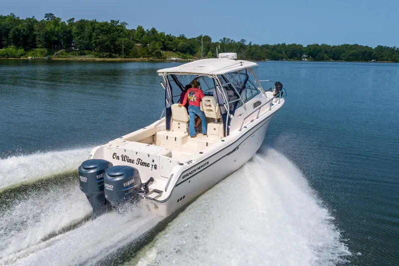 On Wine Time Yacht Photos Pics 2009 Grady-White Chesapeake 290 boat cruising on a calm lake.