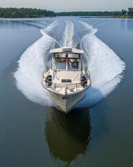 On Wine Time Yacht Photos Pics 2009 Grady-White Chesapeake 290 boat cruising on a calm lake, creating a wake.