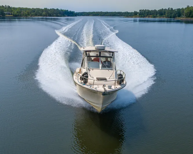 On Wine Time Yacht Photos Pics 2009 Grady-White Chesapeake 290 boat cruising on a calm lake.