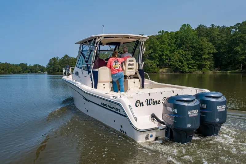 On Wine Time Yacht Photos Pics 2009 Grady-White Chesapeake 290 boat cruising on a calm lake with twin Yamaha engines.