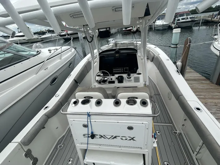  Yacht Photos Pics 2018 Sea Fox 288 Commander boat interior at marina, featuring helm and seating area.