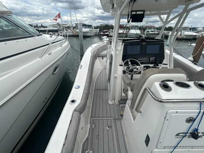  Yacht Photos Pics 2018 Sea Fox 288 Commander boat docked, featuring a sleek helm and spacious deck.